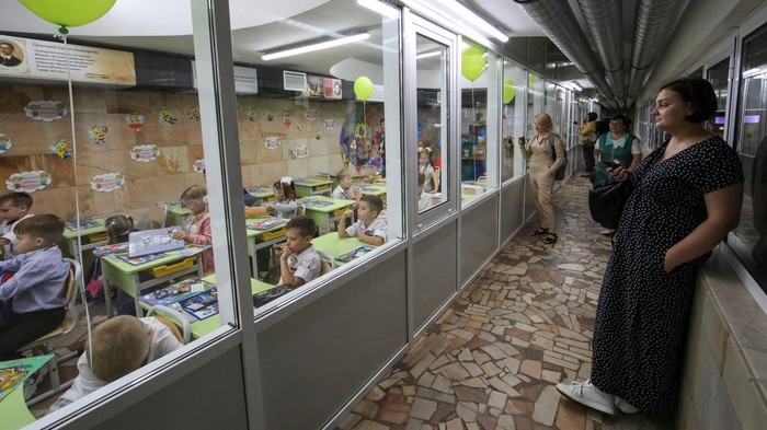 Schoolchildren sit in a classroom set up at a metro station to avoid air attacks, amid Russia's attack on Ukraine, in Kharkiv, Ukraine September 4, 2023. REUTERS/Vyacheslav Madiyevskyy