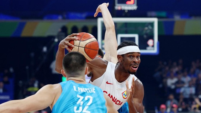 Basketball - FIBA World Cup 2023 - Quarter-Final - Canada v Slovenia - Mall of Asia Arena, Manila, Philippines - September 6, 2023 Canadas Shai Gilgeous-Alexander in action with Slovenias Bine Prepelic REUTERS/Eloisa Lopez