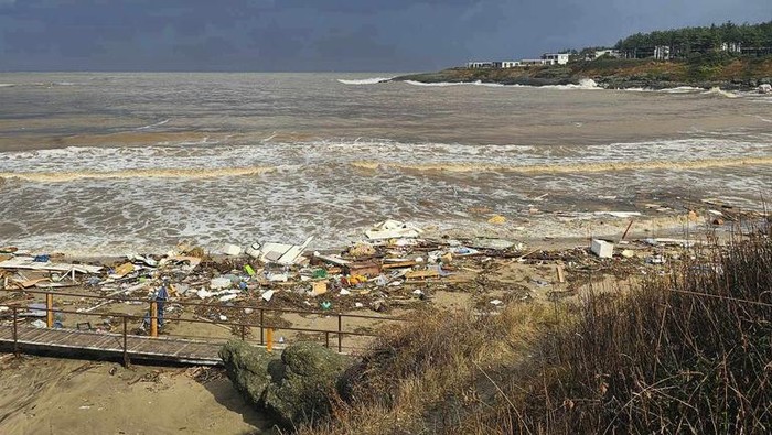 People observe the damage on the beach, after a storm, in Arapya, Bulgaria, Tuesday, Sept. 5, 2023. Bulgaria's Prime Minister Nikolay Denkov said two people died and three others were missing after a storm caused floods on the country's southern Black Sea coast. (AP Photo/Milena Genadieva)