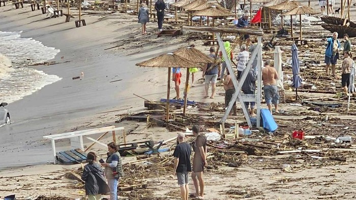 People observe the damage on the beach, after a storm, in Arapya, Bulgaria, Tuesday, Sept. 5, 2023. Bulgaria's Prime Minister Nikolay Denkov said two people died and three others were missing after a storm caused floods on the country's southern Black Sea coast. (AP Photo/Milena Genadieva)