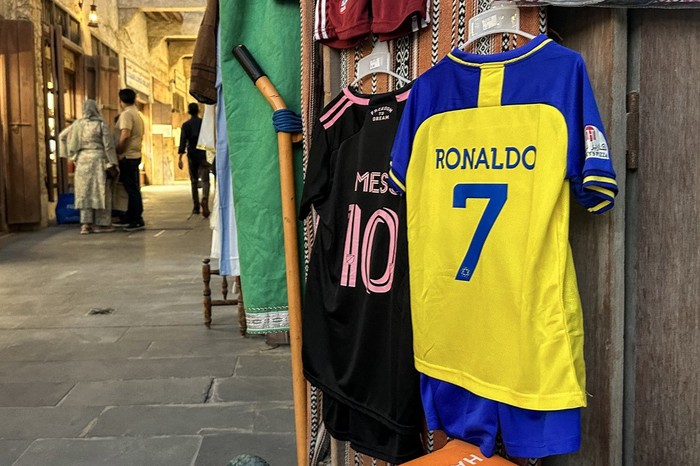 The football jerseys of Portugals forward #7 Cristiano Ronaldo with his new Saudi club al-Nassr and Argentinas forward #10 Lionel Messi with his new US club Inter Miami CF are displayed for sale at a vendors stall at Qatars touristic Souq Waqif bazar in Doha on August 7, 2023. (Photo by KARIM JAAFAR / AFP)