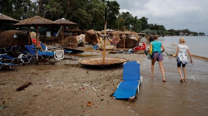 German tourists walk by destroyed beach bars in Kala Nera seaside resort after torrential rains destroyed the infrastructure and caused flooding in the area, in Pelion, central Greece September 6, 2023.  REUTERS/Louisa Gouliamaki