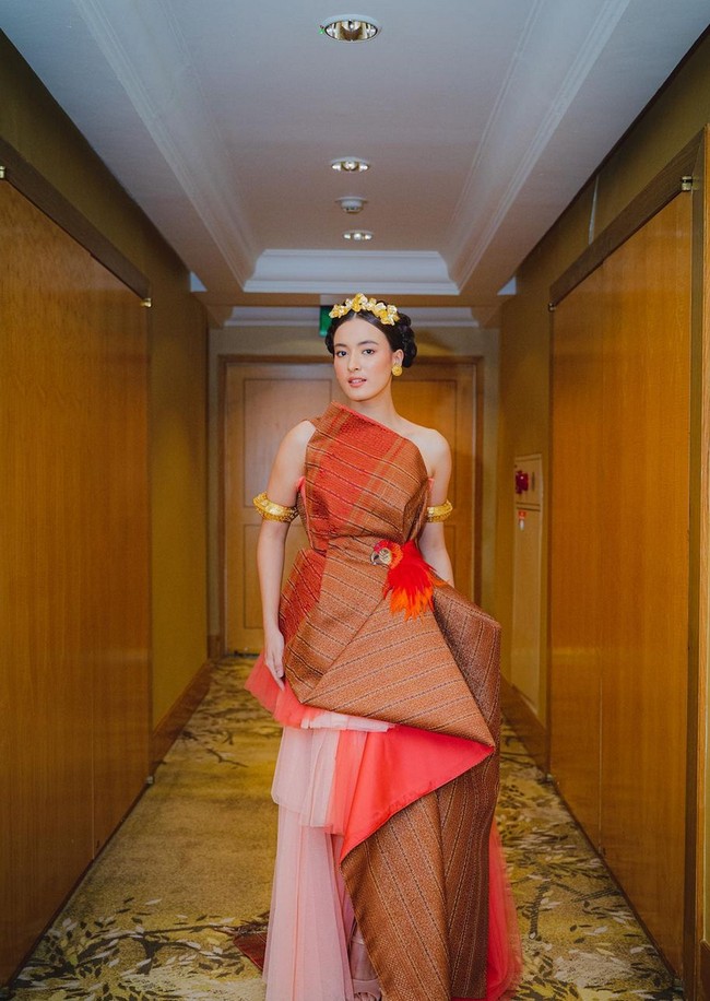 Gaun bernuansa oranye itu juga dipercantik aksen ruffle dan drapery. Foto: Instagram/@mawar_eva @philipekarunia