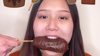 Tantangan selanjutnya Sisca Kohl diwajibkan menyantap corndog. Sebuah corndog berukuran besar dengan berlumur cokelat sudah disiapkan olehnya. Foto: Instagram/siscakohl