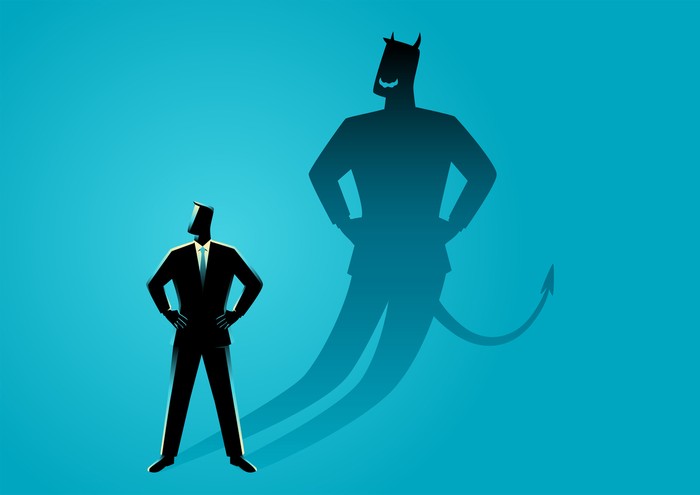 Business concept vector illustration of a businessman with his devil shadow