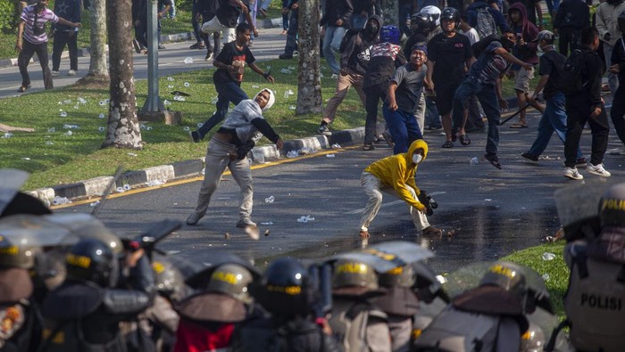 Pengunjuk rasa melempari personel polisi saat aksi unjuk rasa warga Pulau Rempang di Kantor Badan Pengusahaan (BP) Batam, Batam, Kepulauan Riau, Senin (11/9/2023). Aksi yang menolak rencana pemerintah merelokasi mereka tersebut berakhir ricuh. ANTARA FOTO/Teguh Prihatna/Spt.
