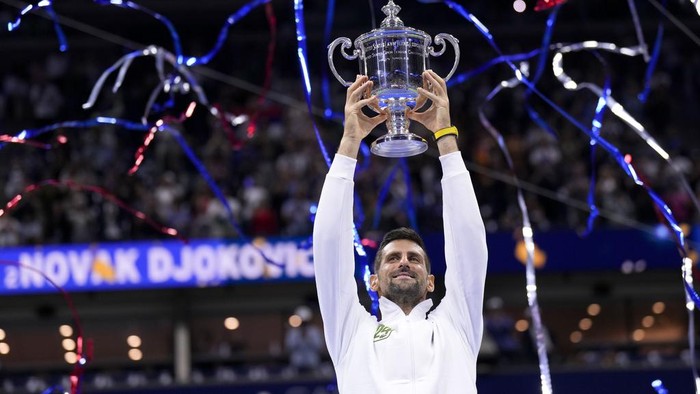 Novak Djokovic, of Serbia, holds up the championship trophy after defeating Daniil Medvedev, of Russia, in the men's singles final of the U.S. Open tennis championships, Sunday, Sept. 10, 2023, in New York. (AP Photo/Manu Fernandez)