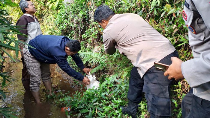 Polisi mengevakuasi bayi dari sungai di Kampung Cibeunteur, Desa Cipicung, Kecamatan Culamega, Kabupaten Tasikmalaya,