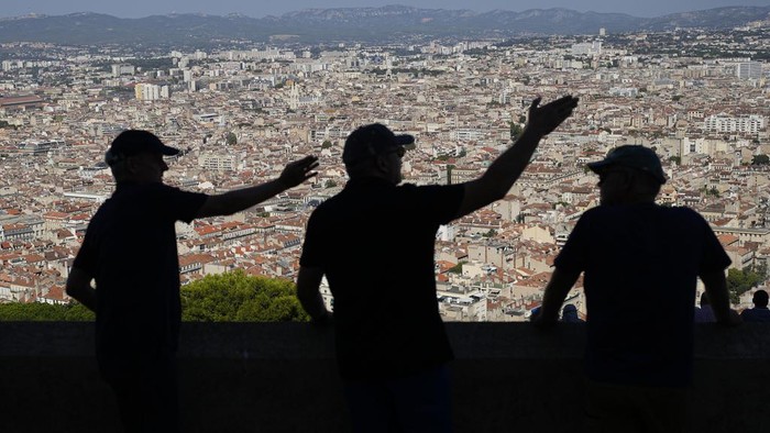 Rugby RWC Daily Life Men gesture as they visit the Notre Dame de la Garde Basilica's viewpoint in Marseille, France, Saturday, Sept. 9, 2023. (AP Photo/Pavel Golovkin)