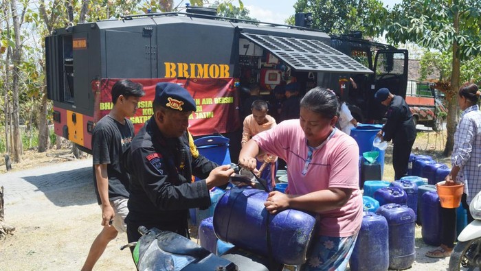 Anggota Brimob Kompi 3 Batalyon C Polda Jatim mendistribusikan air bersih di Bojonegoro.