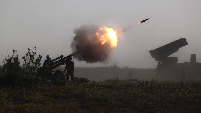Indonesian Marines fire an artillery round during an amphibious landing operation at the Super Garuda Shield multi-national military exercise in Situbondo, East Java, Indonesia, Sunday, Sept. 10, 2023. Thousands of military personnel from the United States, Indonesia and other allied forces showcased their armor capabilities on Sunday in combat drills on the Indonesian island of Java as China takes more aggressive actions in the region. (AP Photo/Trisnadi)