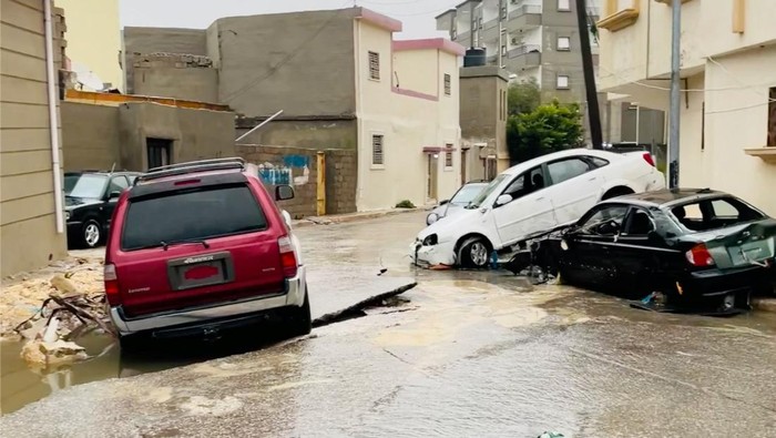 Jalanan di Libya Ambles Gegara Badai Dahsyat A view shows a damaged car on a broken road, after a powerful storm and heavy rainfall hit, in Al Bayda, Libya, September 11, 2023, in this screengrab obtained from social media video. Instagram/@EX5TWD via REUTERS. ATTENTION EDITORS - THIS IMAGE HAS BEEN SUPPLIED BY A THIRD PARTY. MANDATORY CREDIT. NO RESALES. NO ARCHIVES