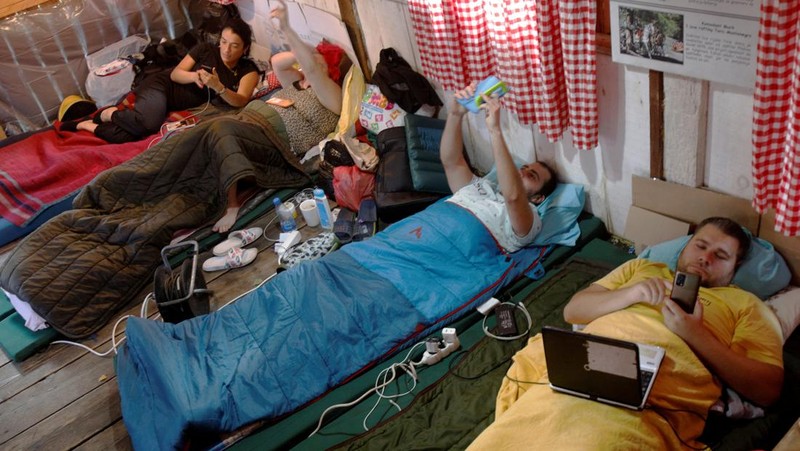 Participants lay inside a hut, as they participate in a satirical contest to mock a popular myth that labels Montenegrins as lazy people, in the village of Brezna, Pluzine, Montenegro, September 6, 2023. REUTERS/Stevo Vasiljevic     TPX IMAGES OF THE DAY