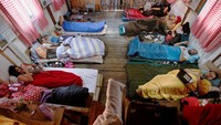 Participants lay inside a hut, as they participate in a satirical contest to mock a popular myth that labels Montenegrins as lazy people, in the village of Brezna, Pluzine, Montenegro, September 6, 2023. REUTERS/Stevo Vasiljevic     TPX IMAGES OF THE DAY