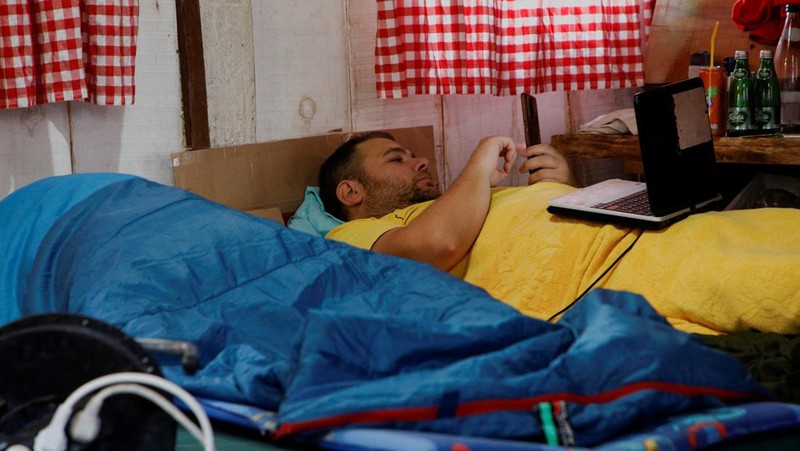 Participants lay inside a hut, as they participate in a satirical contest to mock a popular myth that labels Montenegrins as lazy people, in the village of Brezna, Pluzine, Montenegro, September 6, 2023. REUTERS/Stevo Vasiljevic     TPX IMAGES OF THE DAY