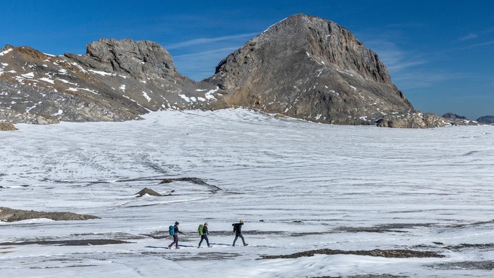 Glaciologist at ETHZ and head of the Glacier Monitoring in Switzerland (GLAMOS) Matthias Huss takes note of the decrease of ice, amid climate change on the Plaine Morte glacier in Crans-Montana, Switzerland, September 5, 2023.  REUTERS/Denis Balibouse