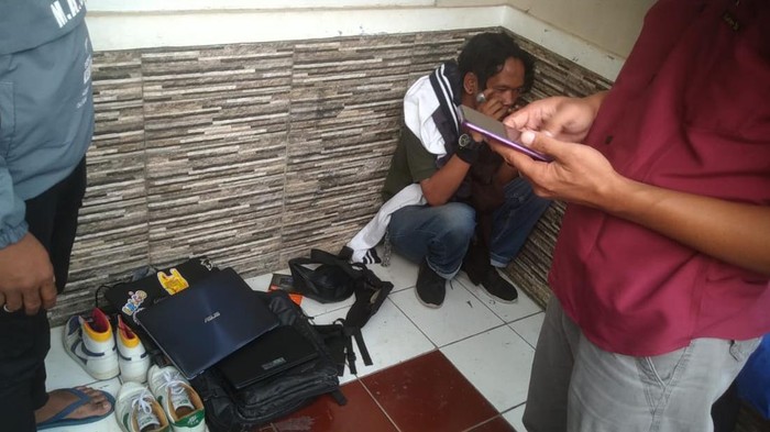 Warga menggeledah pengamen yang ternyata pencuri ponsel dan laptop.