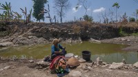 Warga setempat memanfaatkan sisa air pada dasar sungai saat musim kemarau untuk digunakan mencuci dan mandi.