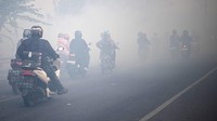 Asap dari kebakaran lahan tersebut mengganggu pengendara yang melintas di Jalan Lintas Palembang-Indralaya.
