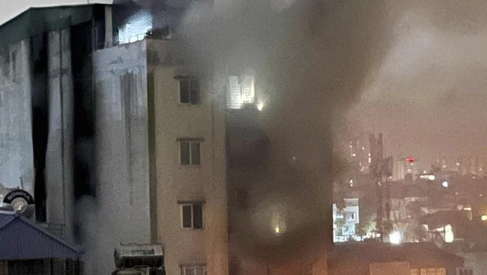 Smoke rises from a building in Hanoi, Vietnam Wednesday, Sept. 13, 2023. Authorities said 