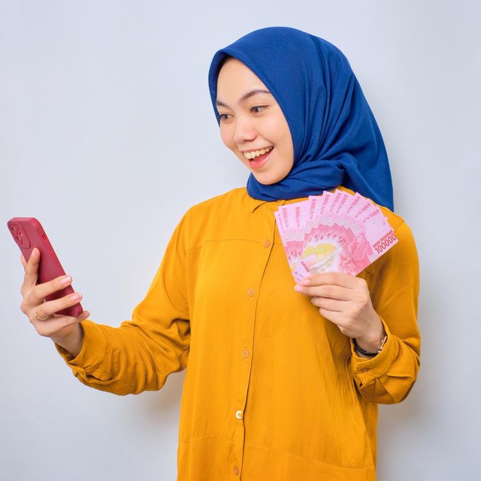 Ilustrasi wanita hijab pegang uang