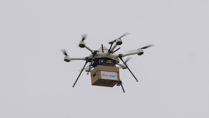 An automated drone taxi hovers in the air with a package during an unveiling of the driverless technology outside Hadassah Medical Center in Jerusalem, Wednesday, Sept 13, 2023. (AP Photo/Ohad Zwigenberg)