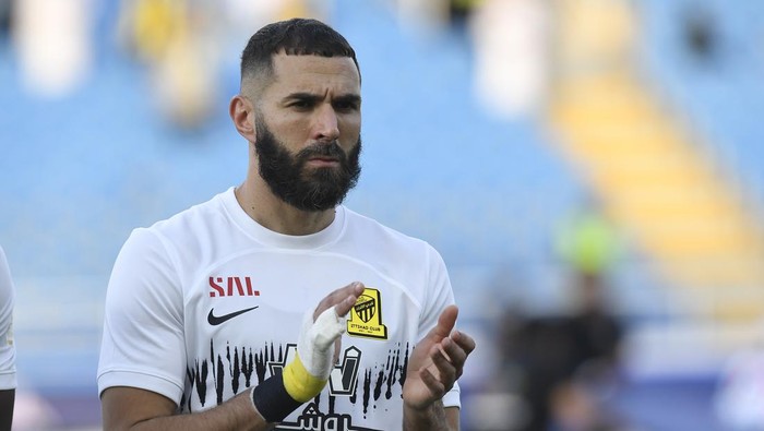 Al Ittihads Karim Benzema greets fans during his team match against Al Raed in the Saudi Professional League, in Buraidah, Saudi Arabia, Monday, Aug. 14, 2023. (AP Photo)