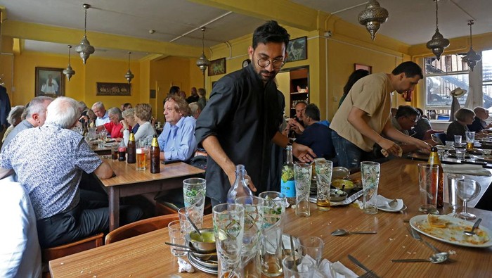 Customers eat lunch in the restaurant of the India Club in London, Britain, September 13, 2023. The iconic restaurant and bar, which as been running for over 70 years, is set to close at the end of this week as the owners of the building it is housed in want to demolish a part of the structure to set up a more modernised hotel. REUTERS/ Susannah Ireland