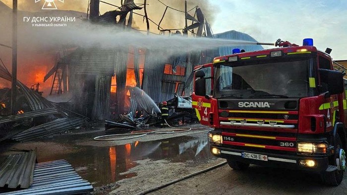 Firefighters work at a site of an industrial warehouse damaged by a Russian drone strike, amid Russia's attack on Ukraine, in Lviv, Ukraine September 19, 2023. Press service of the State Emergency Service of Ukraine in Lviv region/Handout via REUTERS ATTENTION EDITORS - THIS IMAGE HAS BEEN SUPPLIED BY A THIRD PARTY. DO NOT OBSCURE LOGO.