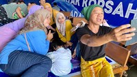 Nyak Kopsah tak segan menyapa langsung pengunjung warungnya. Ia menyapa, mengobrol, dan bahkan melayani permintaan foto bersama. Foto: detikfood  