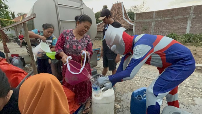 Pria berkostum Superhero Ultraman ikut membantu air bersih kepada warga terdampak kekeringan di Pati, Rabu (20/9/2023).