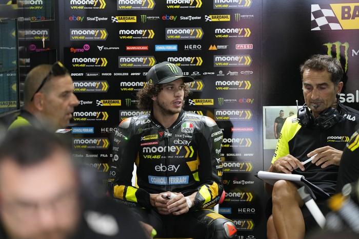 Mooney VR46 Racing Team (Ducati) rider Marco Bezzecchi, center, sits with his team members at Pit Lane during Moto GP Bharat practice session at the Buddh International Circuitin Greater Noida, on the outskirts of New Delhi, India Friday, Sept. 22, 2023. (AP Photo/Manish Swarup)