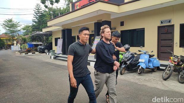 Bule asal Amerika Serikat Arthur Leigh Welohr tersangka pembunuhan kepada mertuanya sendiri di Banjar, Jawa Barat, saat dibawa polisi.