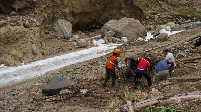 Police and firefighters dig for survivors after homes of the 