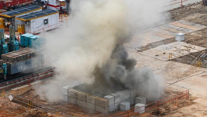 Smoke rises after a 100kg World War II-era aerial bomb is detonated at a construction site in Singapore. - AFP PIC