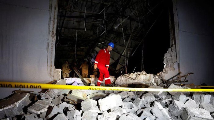 An emergency worker walks over rubble at the site following a fatal fire at a wedding celebration, in the district of Hamdaniya in Iraqs Nineveh province, Iraq, September 27, 2023. REUTERS/Khalid Al-Mousily