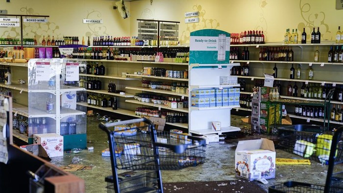Shown is the aftermath of a ransacked liquor store in Philadelphia, Wednesday, Sept. 27, 2023. Police say groups of teenagers swarmed into stores across Philadelphia in an apparently coordinated effort, stuffed bags with merchandise and fled. (AP Photo/Matt Rourke)