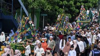 Umat islam menggotong perahu hias saat mengikuti pawai Ngarak Perahu di kawasan Pasar Lama, Tangerang, Banten, Kamis (28/9/2023). Kegiatan mengarak perahu dan membagikan makanan dari hasil bumi bagi warga tersebut untuk memperingati hari kelahiran Nabi Muhammad SAW.  ANTARA FOTO/Sulthony Hasanuddin 