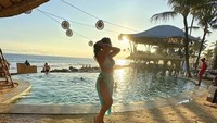 Salah satunya ada momen saat nongkrong di sebuah club yang ada di Bali. Ia pun berpose dengan pemandangan kolam renang. Foto: Instagram @thererose_