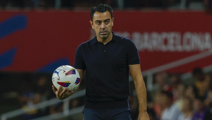 Barcelonas head coach Xavi Hernandez holds the ball during a Spanish La Liga soccer match between Barcelona and Sevilla, at the Olympic Stadium of Montjuic in Barcelona, Spain, Friday, Sept. 29, 2023. (AP Photo/Joan Monfort)