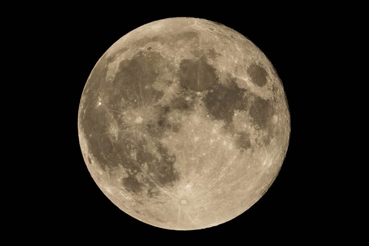 An exhaust pipe from a diesel generator spouts fumes as the September full moon, known as the Harvest Moon, rises in the background, in Beirut, Lebanon, Friday, Sept. 29, 2023. (AP Photo/Hassan Ammar)