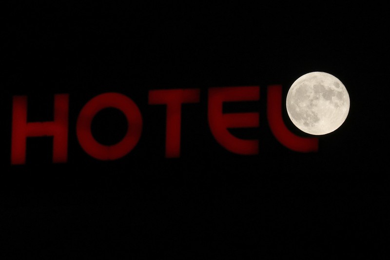 An exhaust pipe from a diesel generator spouts fumes as the September full moon, known as the Harvest Moon, rises in the background, in Beirut, Lebanon, Friday, Sept. 29, 2023. (AP Photo/Hassan Ammar)