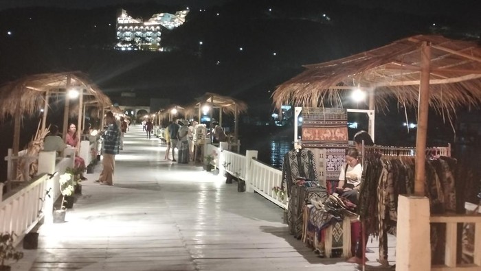 Sejumlah wisatawan berburu suvenir di Dermaga Putih Labuan Bajo pada malam hari, Minggu (1/10/2023). (Ambrosius Ardin)