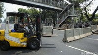 Petugas menutup jalan dengan menggunakan alat berat di Jalan Medan Merdeka Barat, Jakarta, Senin (2/10/2023).  