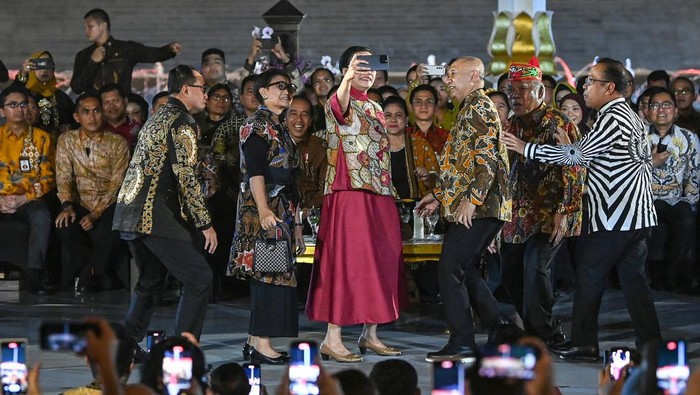 Presiden Joko Widodo (kedua kanan) didampingi Ibu Negara Iriana Joko Widodo menyaksikan peragaan busana batik dalam acara Istana Berbatik di depan Istana Merdeka, Jakarta, Minggu (1/10/2023). Perhelatan yang melibatkan 500 orang dalam peragaan busana batik mulai dari pejabat negara, petinggi kementerian/lembaga dan BUMN, perwakilan kerajaan-kerajaan nusantara hingga para duta besar tersebut untuk memperingati Hari Batik Nasional yang diperingati setiap 2 Oktober. ANTARA FOTO/Sigid Kurniawan/nz.