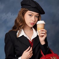 Ada foto AI Rebecca yang bergaya feminin dengan blazer dan tas merah yang ditenteng. Foto: dok. Instagram/@rklopper