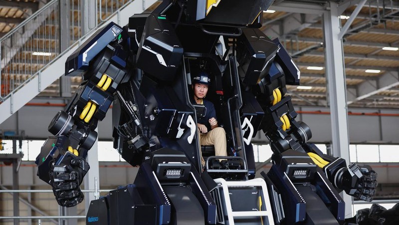CEO Ryo Yoshida poses for a photograph with ARCHAX, a giant human-piloted robot developed by his start-up Tsubame Industries Co., in Yokohama, south of Tokyo, Japan September 27, 2023.  REUTERS/Issei Kato