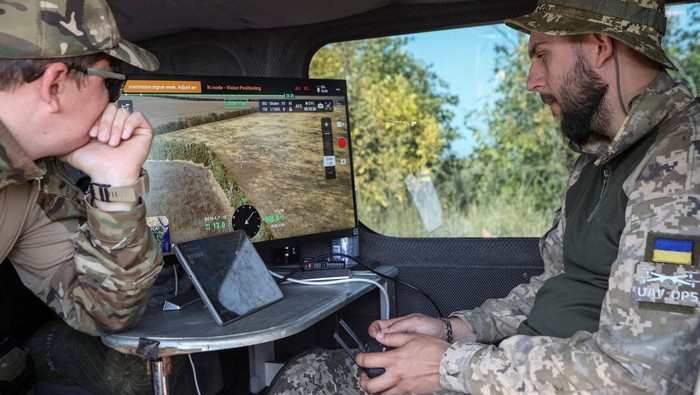 A member of the volunteer organization 'Postup' operates a drone with a metal detector for mine searching during demining a field, amid Russia's attack on Ukraine, near the town of Derhachi, Kharkiv region, Ukraine October 1, 2023. REUTERS/Sofiia Gatilova