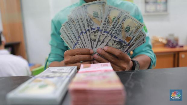 Petugas menghitung uang di tempat penukaran uang Dolar Asia, Melawai, Blok M, Jakarta, Selasa, (3/10). (CNBC Indonesia/Muhammad Sabki)