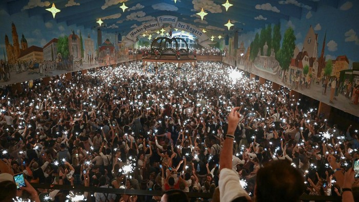 Attendees light sparklers to celebrate at the end of the Oktoberfest, in Munich, Germany, October 3, 2023. REUTERS/Angelika Warmuth